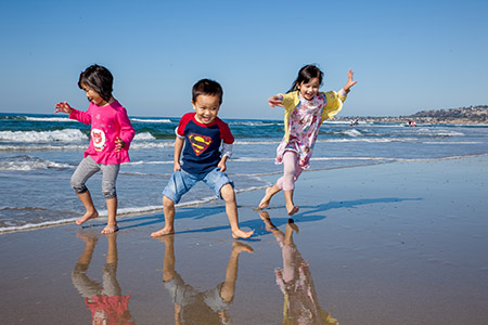 Cousins running on the beach